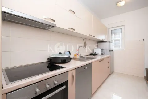 Kitchen equipped with kitchen units, built-in oven, hob, and refrigerator. - image 3