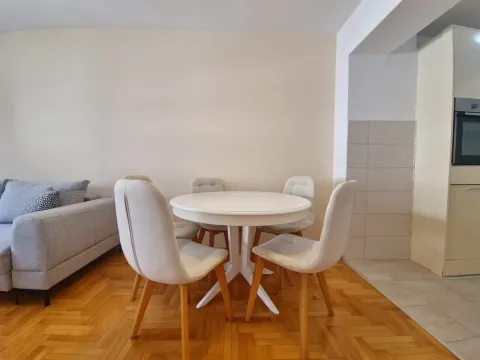 Dining table with white chairs in the living room. - image 9