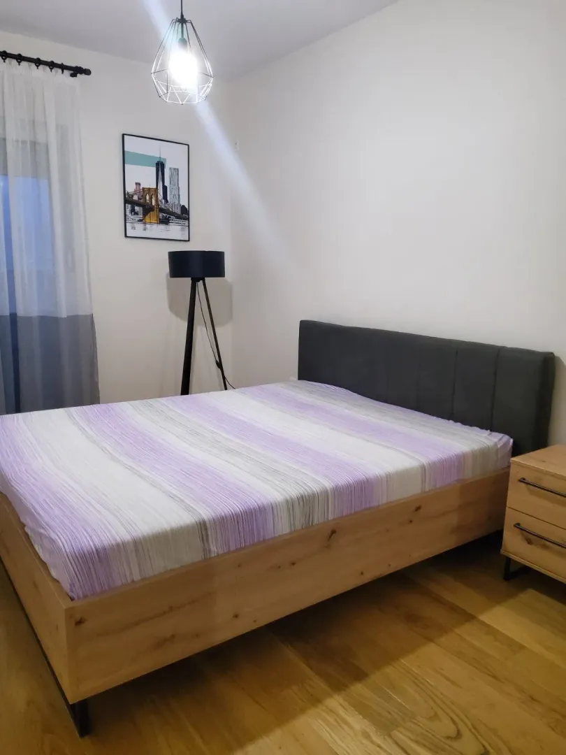 Furnished bedroom with a double bed and a nightstand.