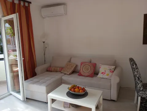 Living room with a corner sofa, coffee table, and access to the terrace. - image 4