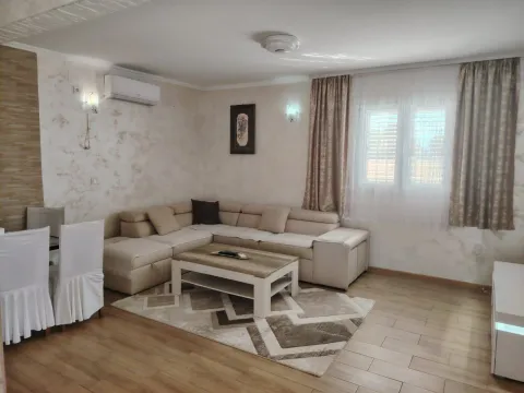 Spacious living room with a sofa set and a dining table. - image 2