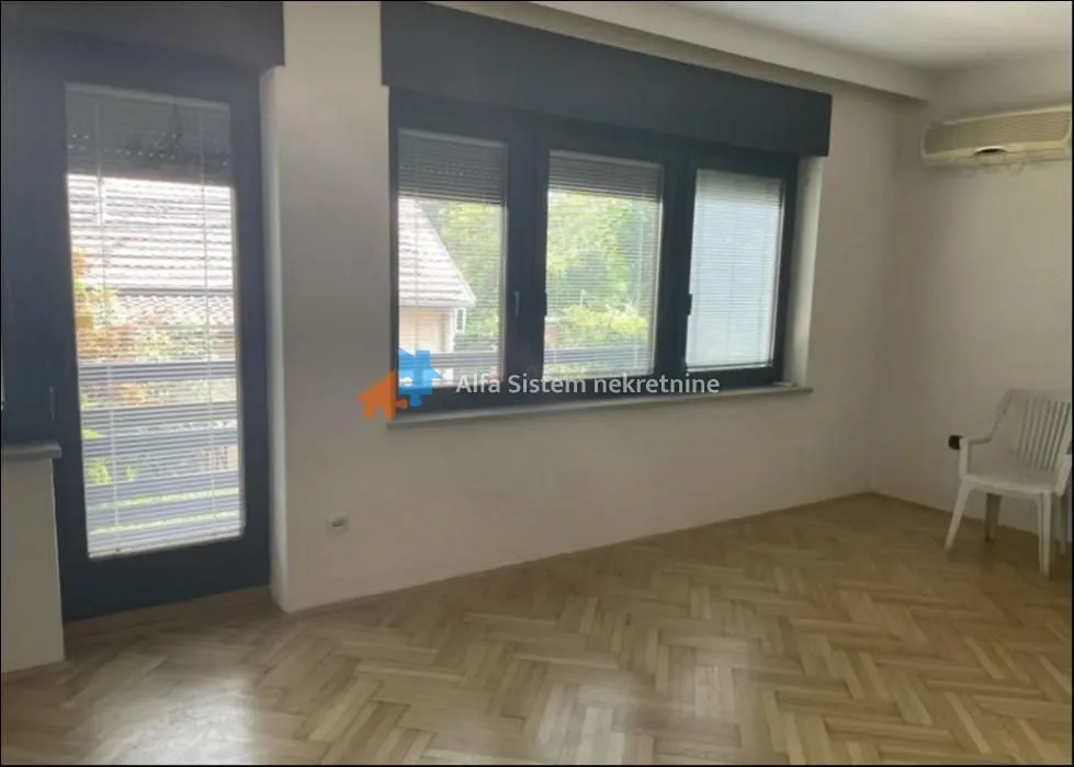 Empty room with parquet flooring, windows, and a door leading to the terrace.