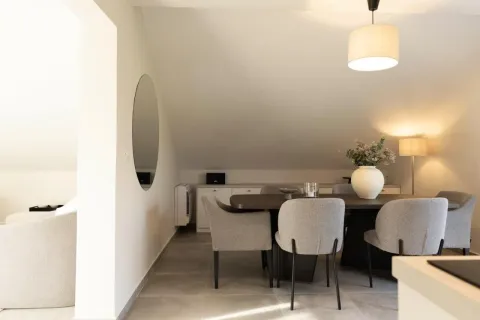 Modern dining area with a table, chairs, and a decorative vase. - image 18