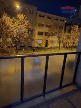 View from the balcony of the illuminated street and building at night. - image 13