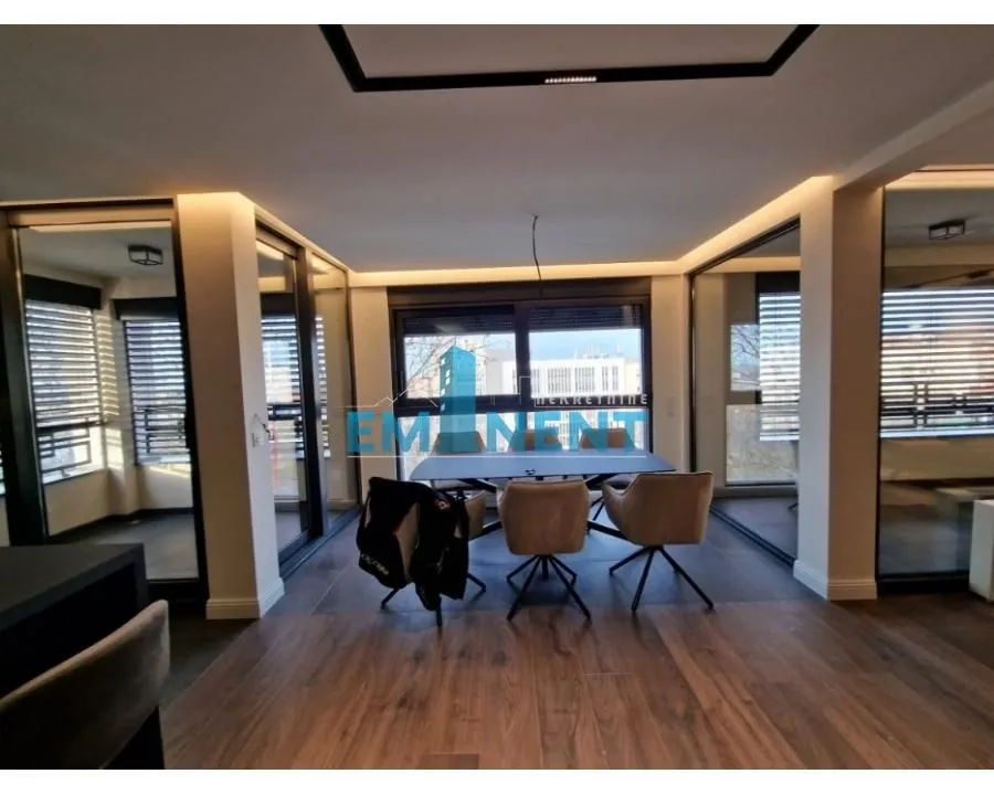 Dining area with a table and chairs within a modern interior.