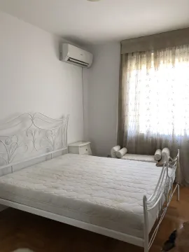 Bright bedroom featuring a white metal bed frame and an air conditioning unit. - image 22
