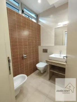 Modern bathroom with a washbasin, toilet, and bidet. - image 21
