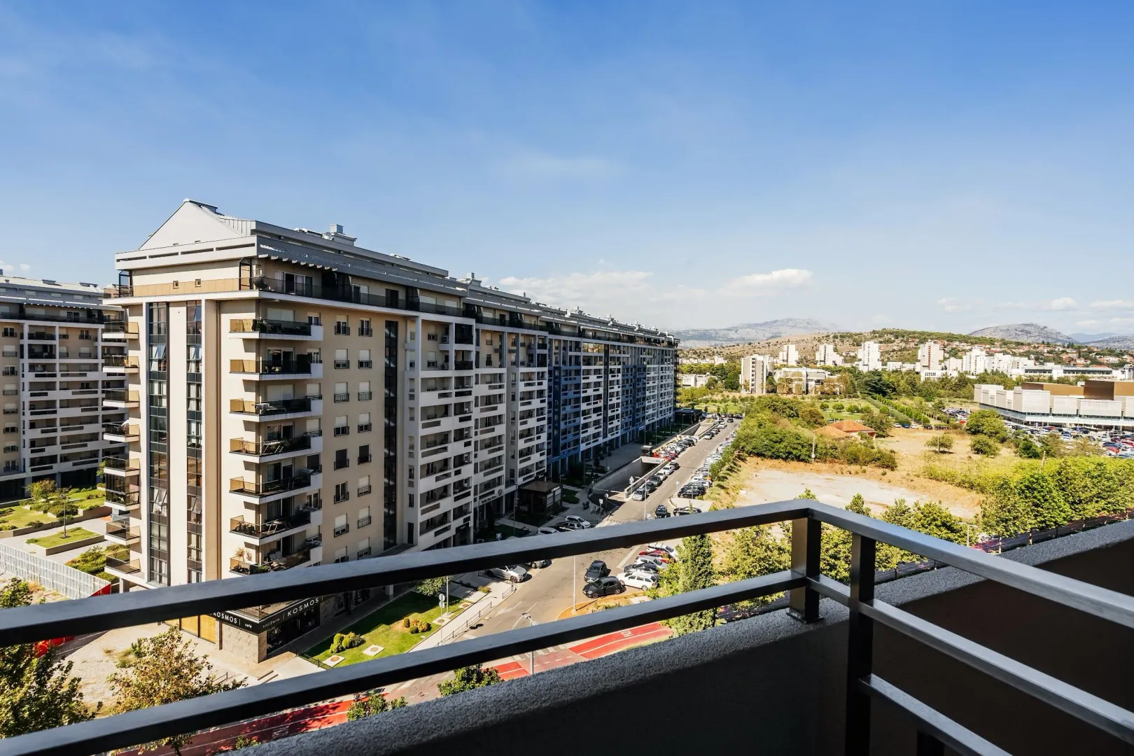 View from the terrace towards the surrounding residential buildings and cityscape.