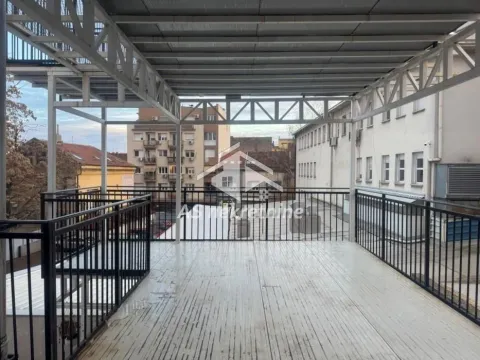 Large covered terrace with metal structure and view of surrounding buildings. - image 12