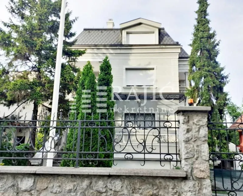 Exterior view of the house with a yard and fence.