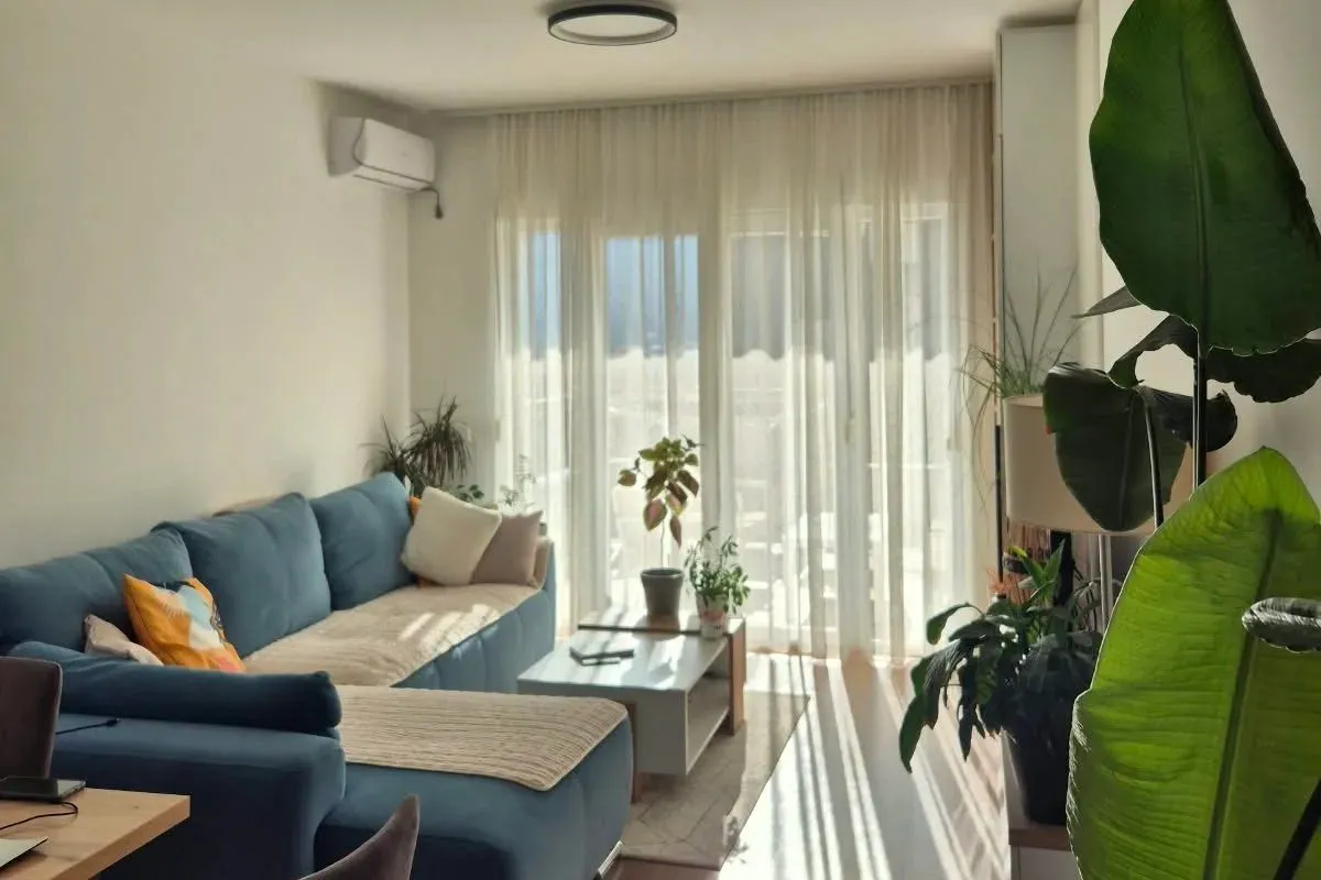 Living room with a sofa and access to the terrace.
