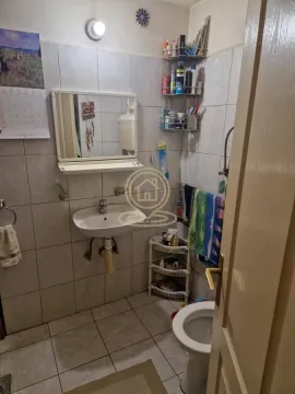 Smaller bathroom with a washbasin, mirror, and toilet. - image 7