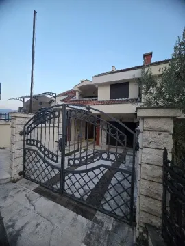 Exterior of a family house with a yard gate and paved courtyard. - image 18