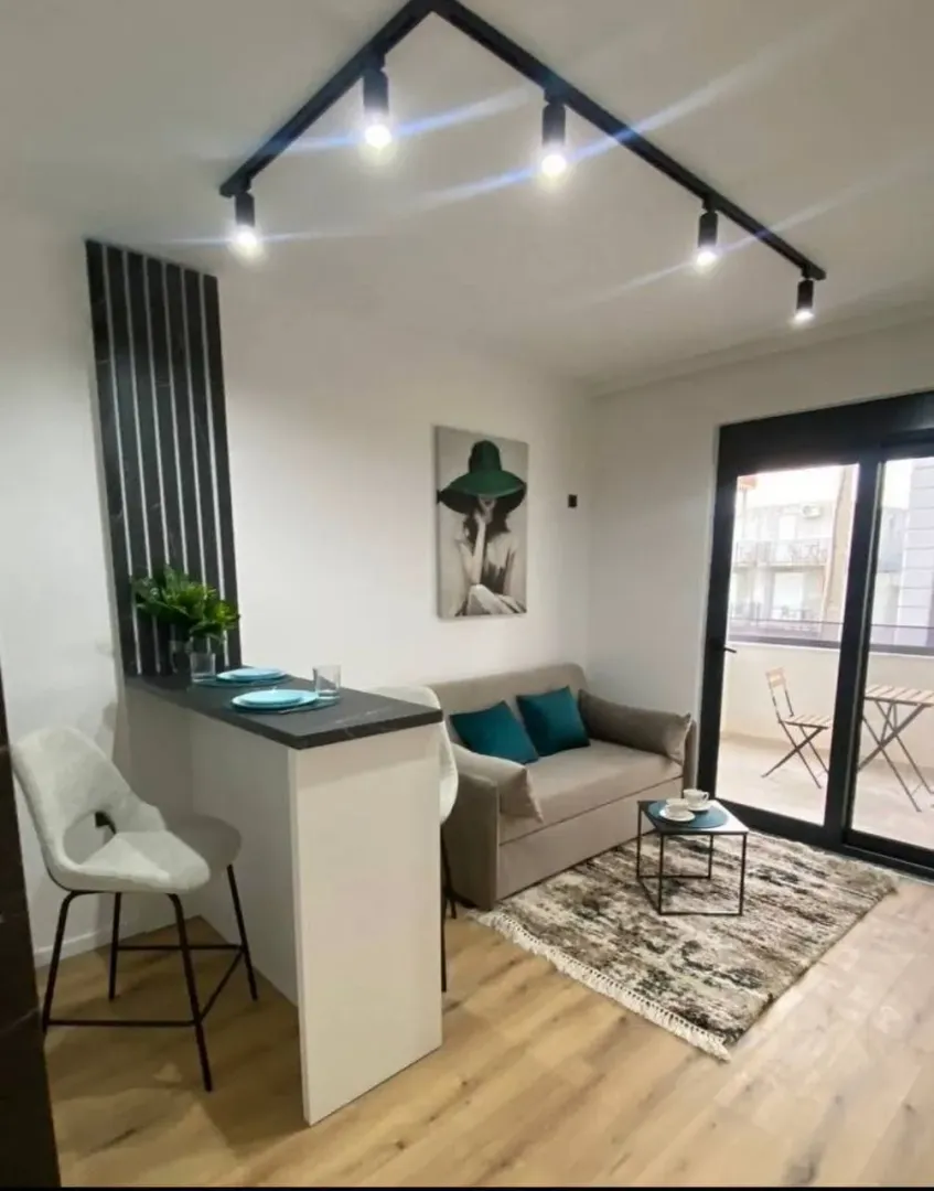 Living room with a breakfast bar and dining area.