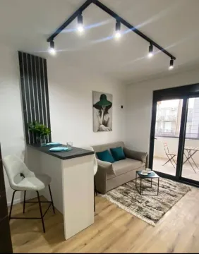 Living room with a breakfast bar and dining area. - image 2