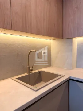 Kitchen area showing the sink, faucet, and upper cabinets with under-cabinet lighting. - image 13