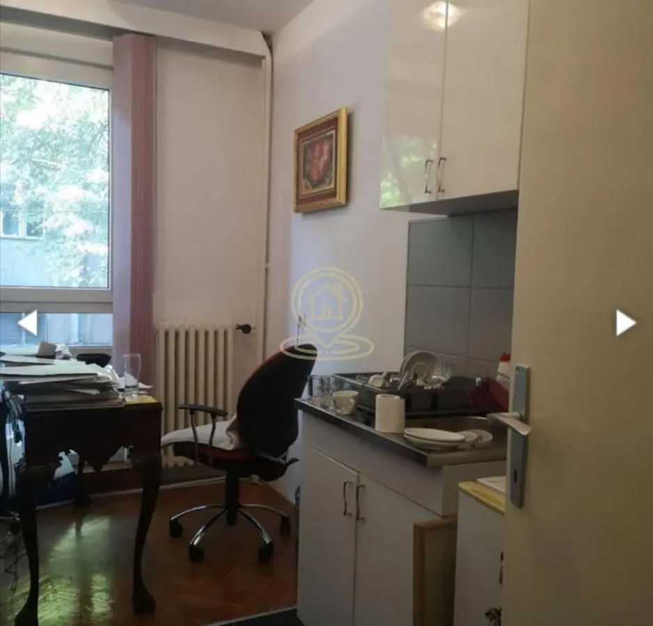 Smaller kitchen with a sink and a desk in the same room.