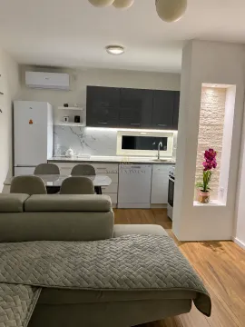Living room with dining area and kitchen in the background. - image 10