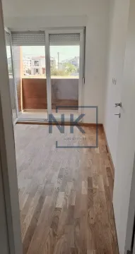 Empty room with hardwood flooring and access to a balcony. - image 2