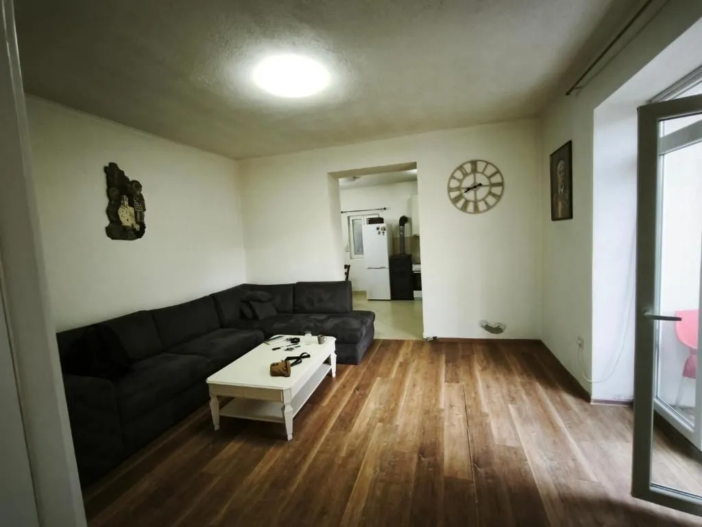 Living room with a sectional sofa, coffee table, and a view into the kitchen.