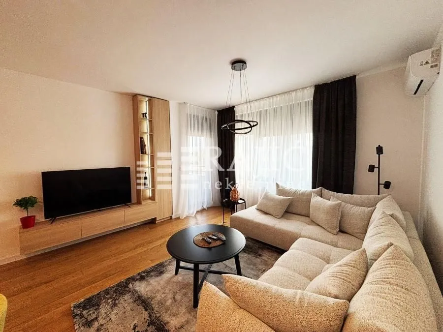 Modern and bright living room with a sectional sofa and TV unit.