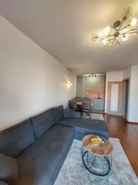 Living room with a sectional sofa connected to the dining area and kitchen. - image 3