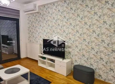 Living room with a TV, furniture, and decorative wallpaper. - image 4
