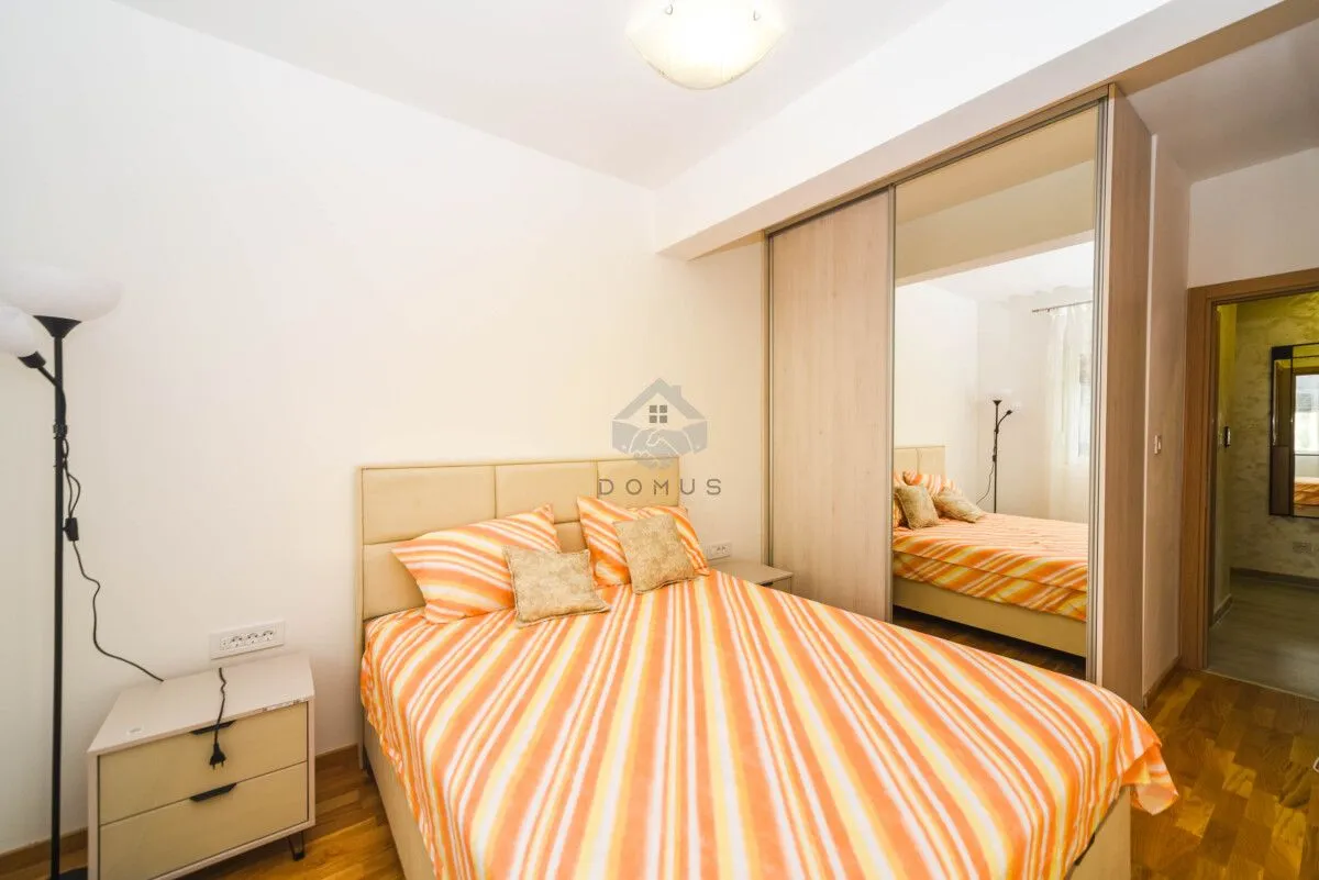 Bedroom with a double bed and a fitted wardrobe with a mirror.