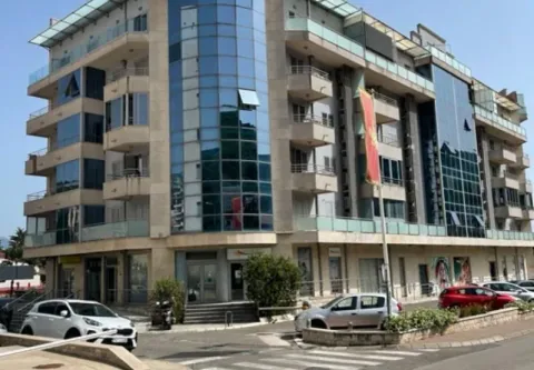 Exterior view of the facade of a modern residential and commercial building with glass elements. - image 2