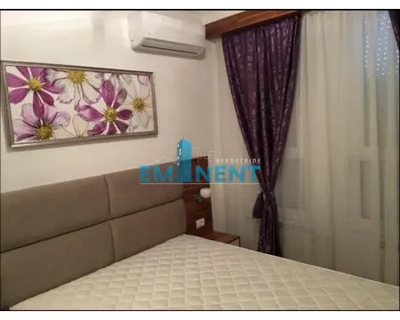 Bedroom with a double bed, artwork and a wall-mounted air conditioner. - image 7
