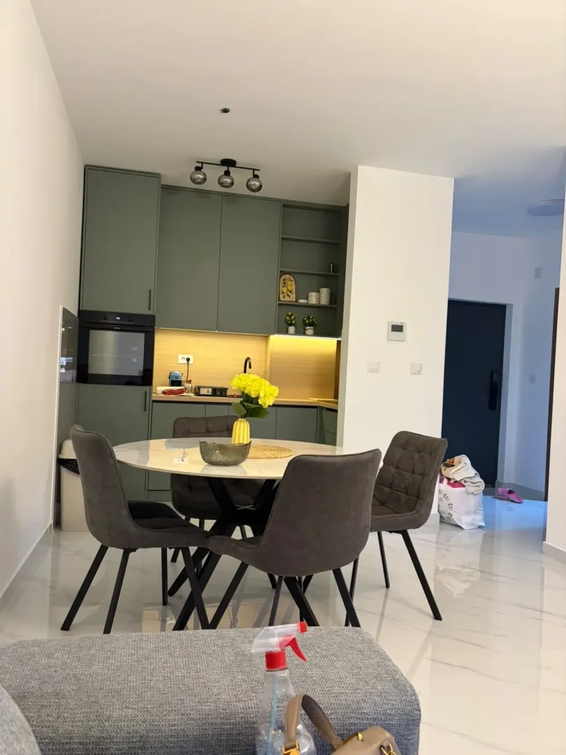 Modern kitchen with a dining table and grey chairs.