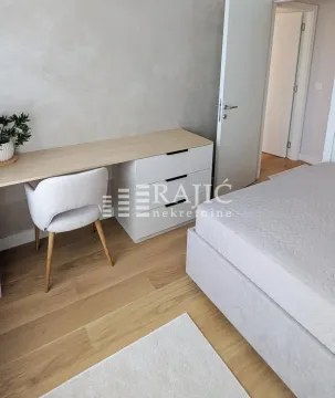 Modern bedroom with a double bed, desk, and chair. - image 11
