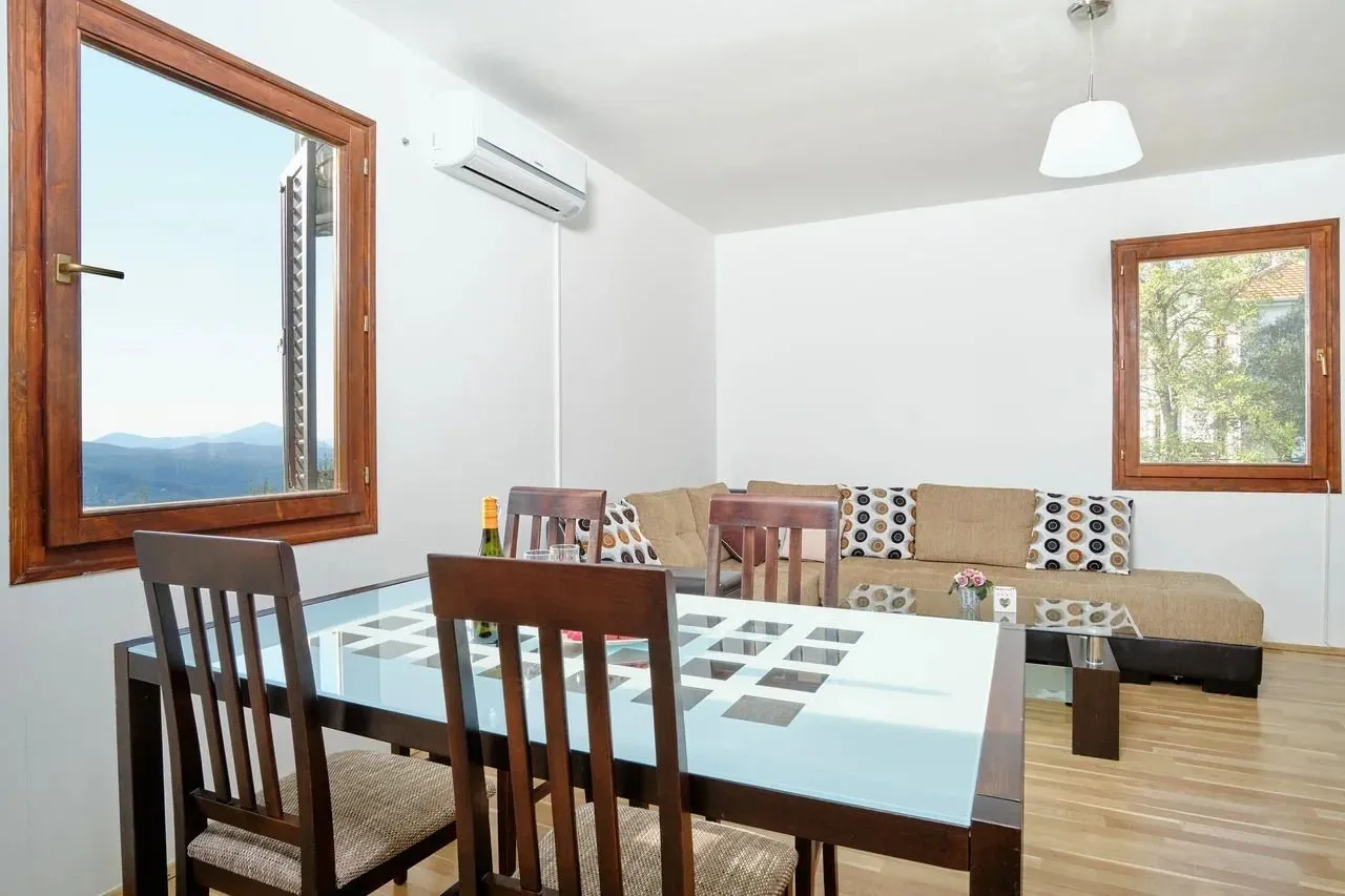 Living room with a dining area, wooden table and sofa set.