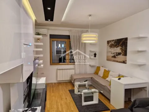 Living room with sofa, coffee table and TV unit. - image 16