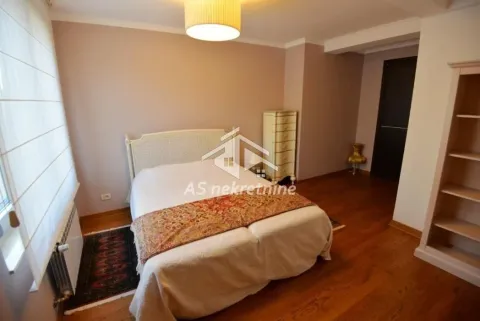 Nameštena spavaća soba sa bračnim krevetom, komodom i drvenim podom. - image 11