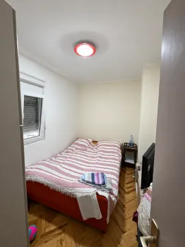 Small bedroom with a double bed, window, and parquet flooring. - image 6