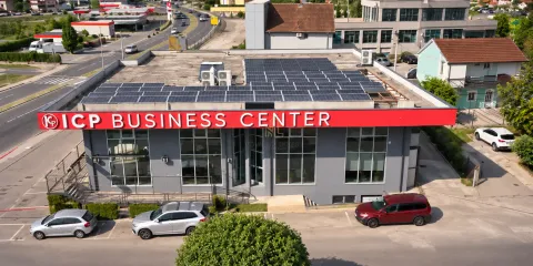 Aerial view of the business center with solar panels on the roof and parking space in front. - image 3