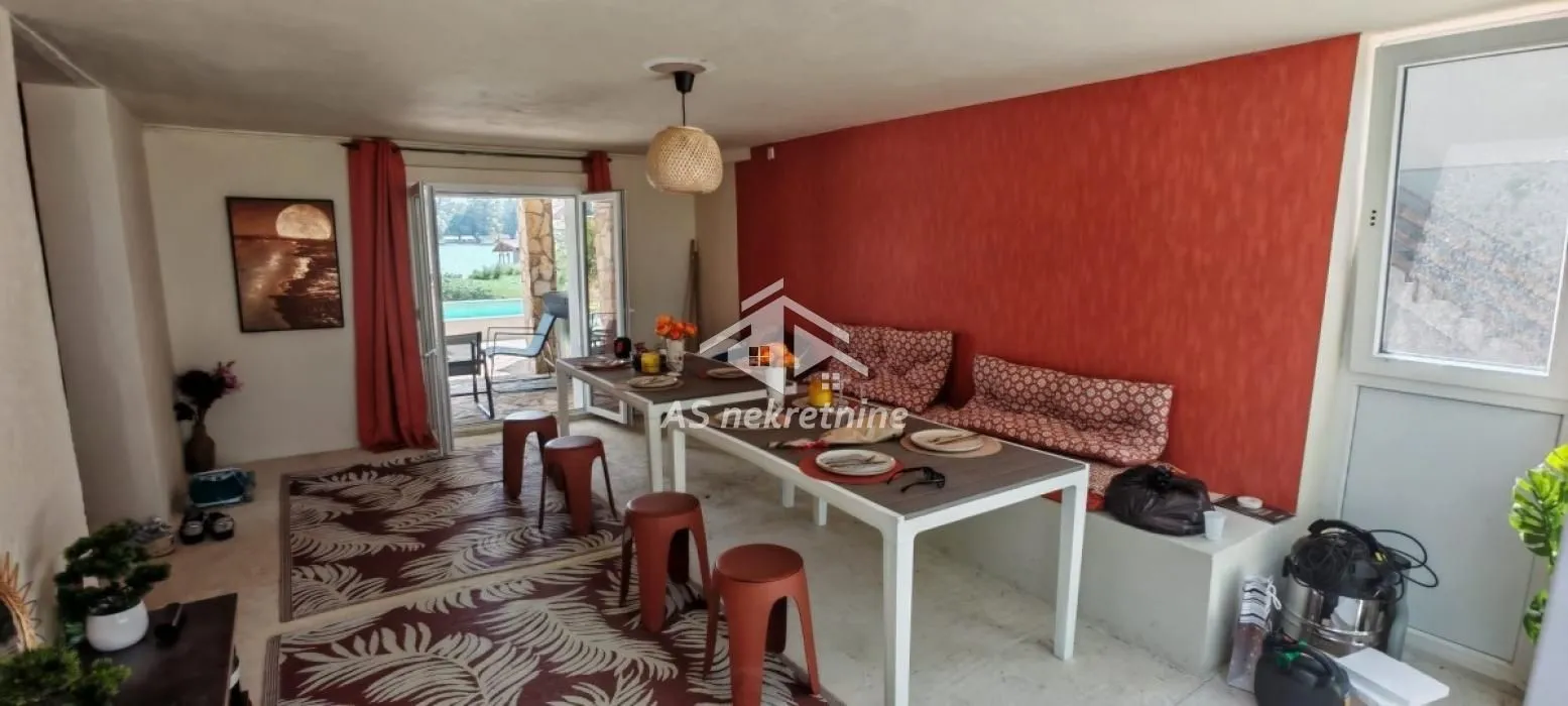 Spacious living room with a dining table and terrace access.