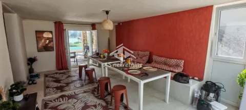 Spacious living room with a dining table and terrace access. - image 32