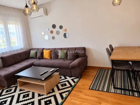 Living room with a sectional sofa, coffee table, and dining table. - image 3