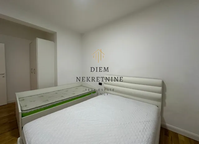 Bedroom with two beds and a wardrobe.