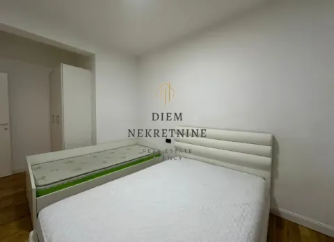 Bedroom with two beds and a wardrobe. - image 7