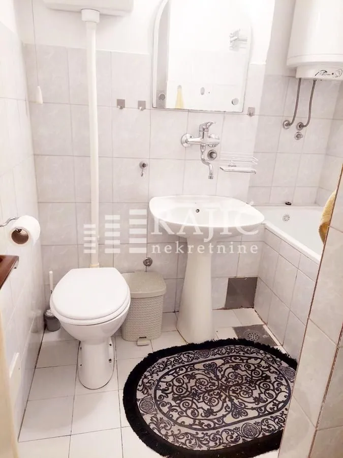 Small bathroom with a sink, toilet, and bathtub.