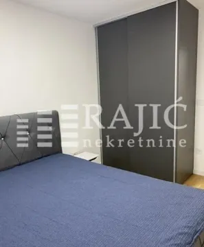 Bedroom with a double bed and a fitted wardrobe. - image 4