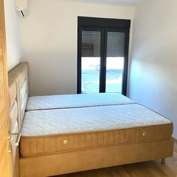 Bedroom with a double bed and a door leading to the terrace.