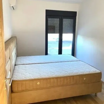 Bedroom with a double bed and a door leading to the terrace. - image 4