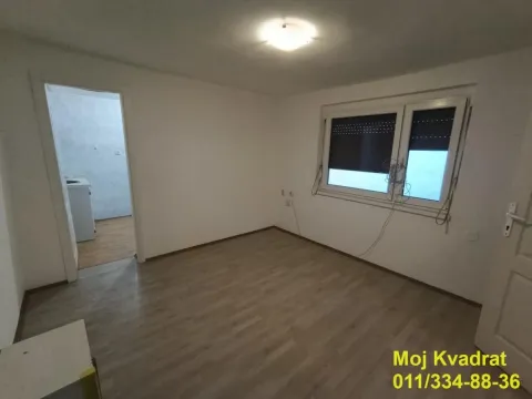Empty room with laminate flooring and a window, with a view into the adjacent room. - image 6
