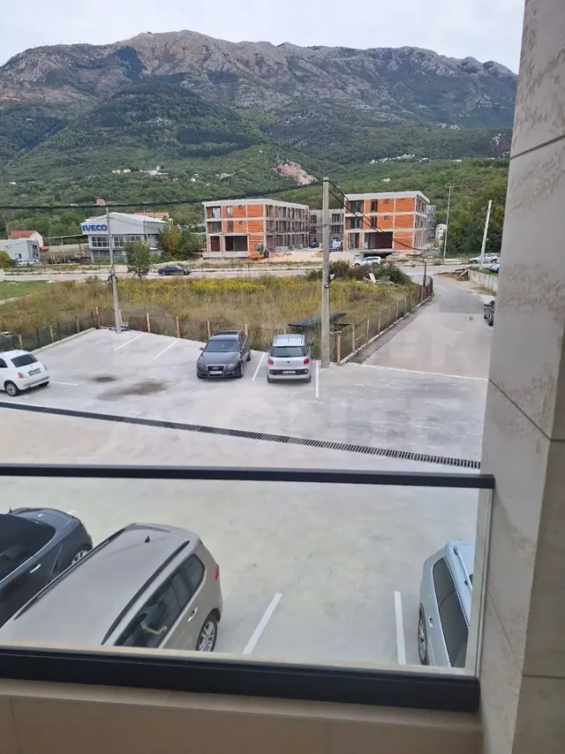 View from the terrace overlooking the parking area and surrounding mountains.
