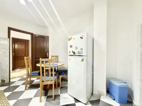 Kitchen with dining table and refrigerator. - image 3