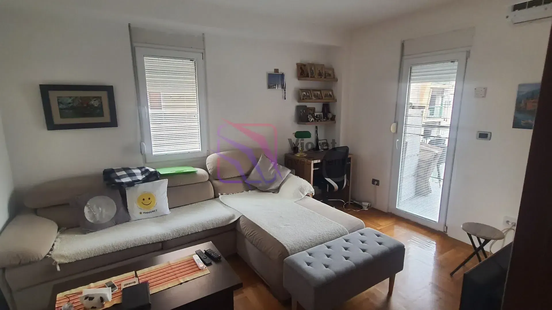 Living room with a sectional sofa, coffee table, and a work corner.